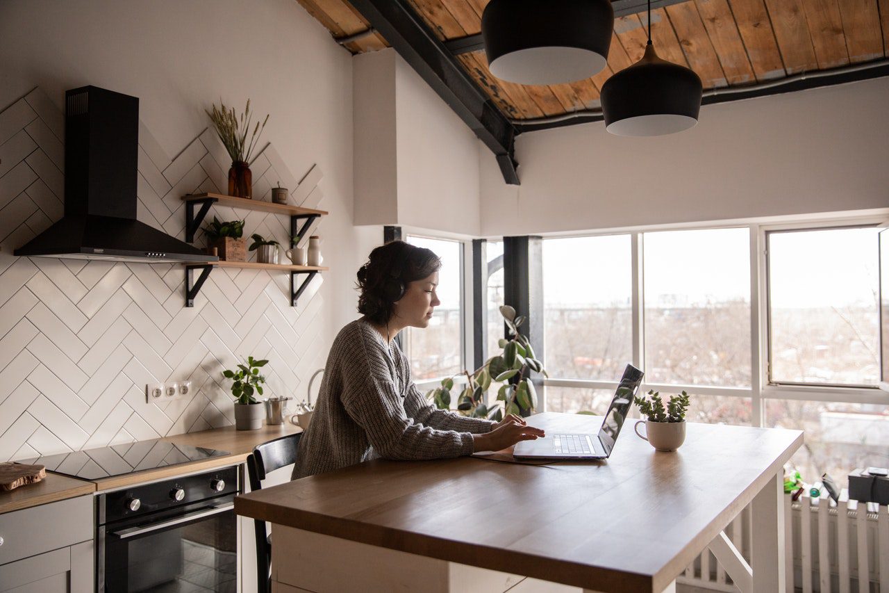 pexels-anamul-rezwan-1216589 (1) Young woman surfing laptop in kitchen